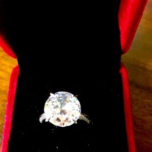 8 ct round diamonique with diamonique accents.  Size 6. Sterling Silver.